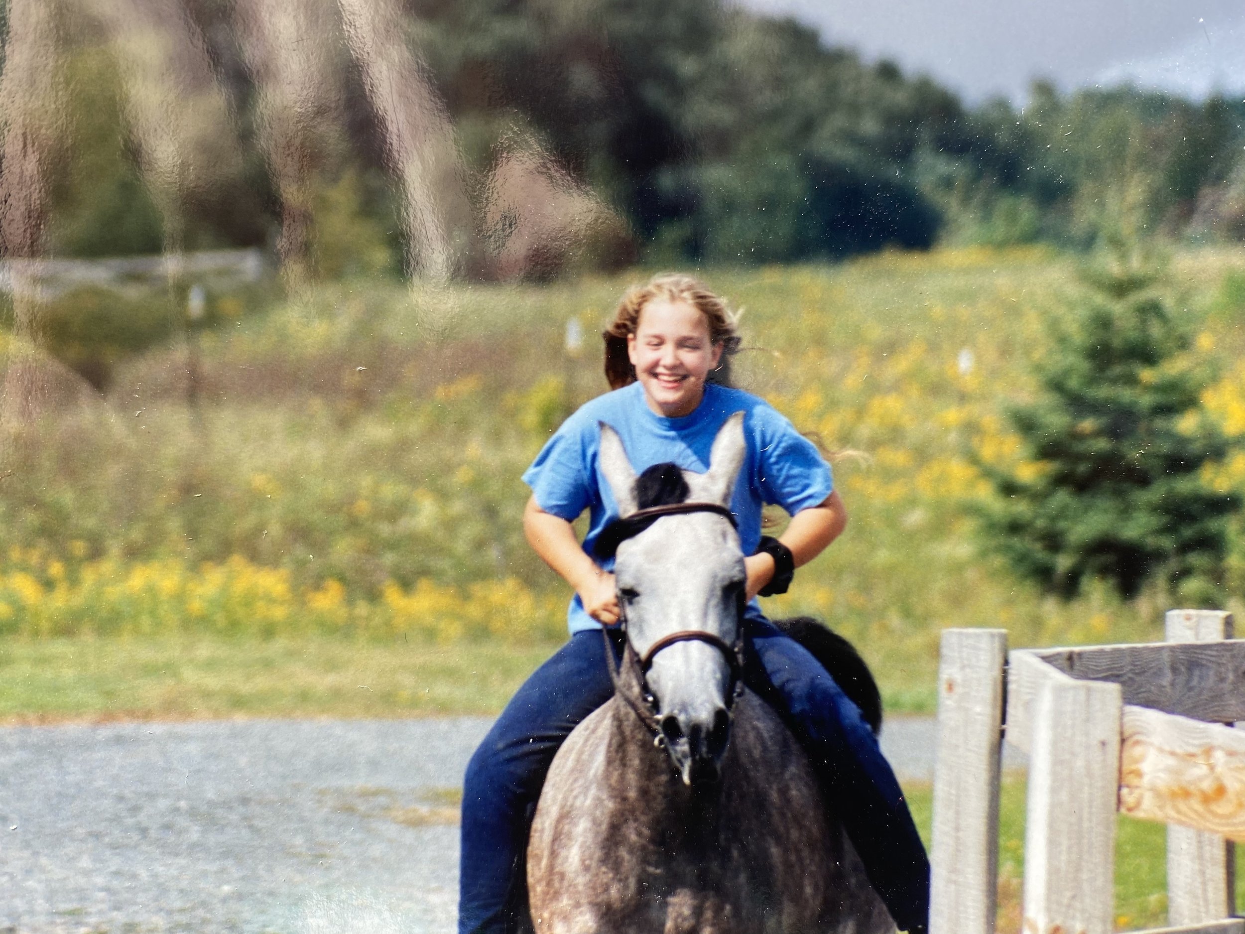 A young Brooke riding a horse on bareback